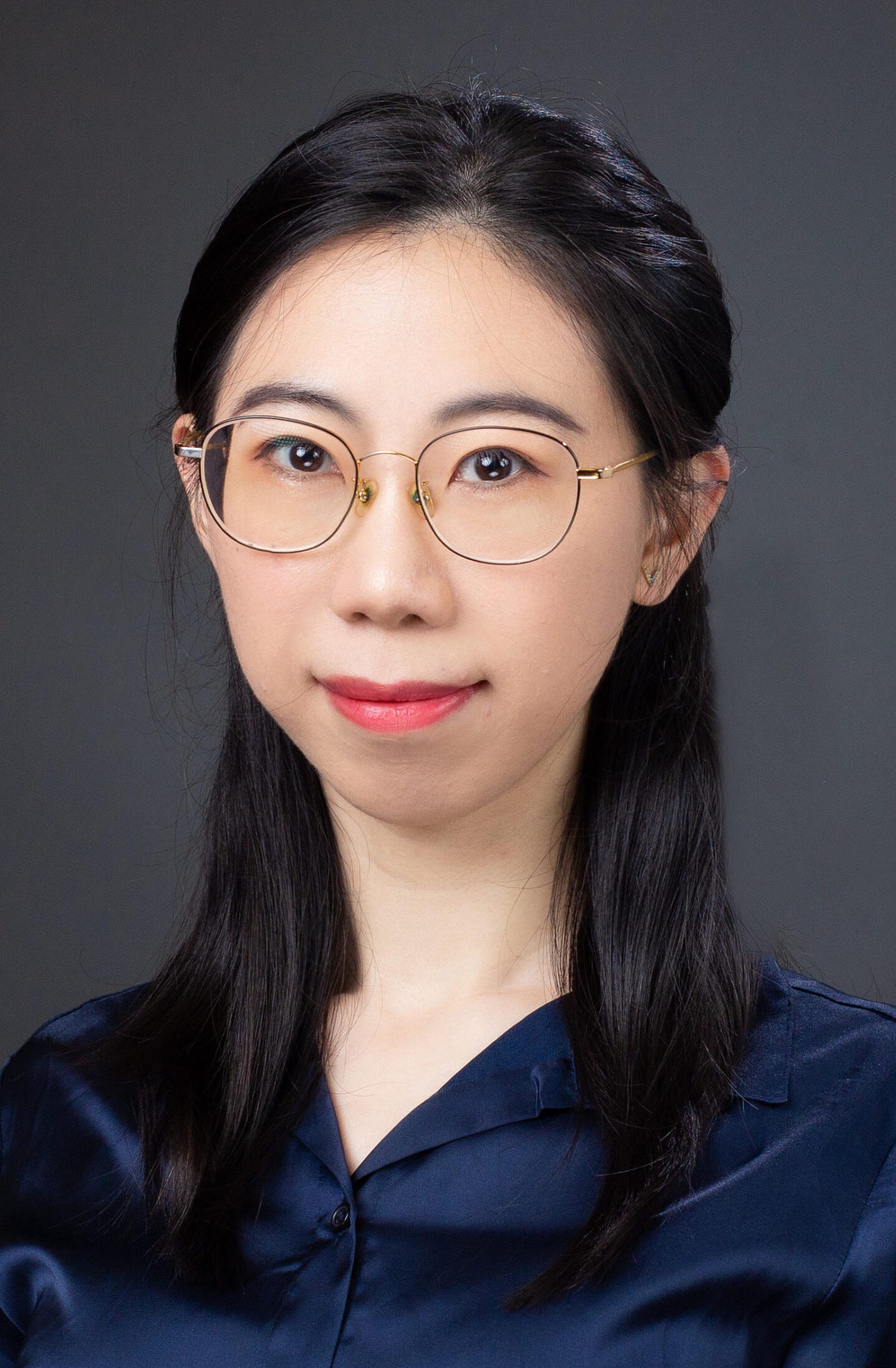 Dr. Wang in a blue silk blouse